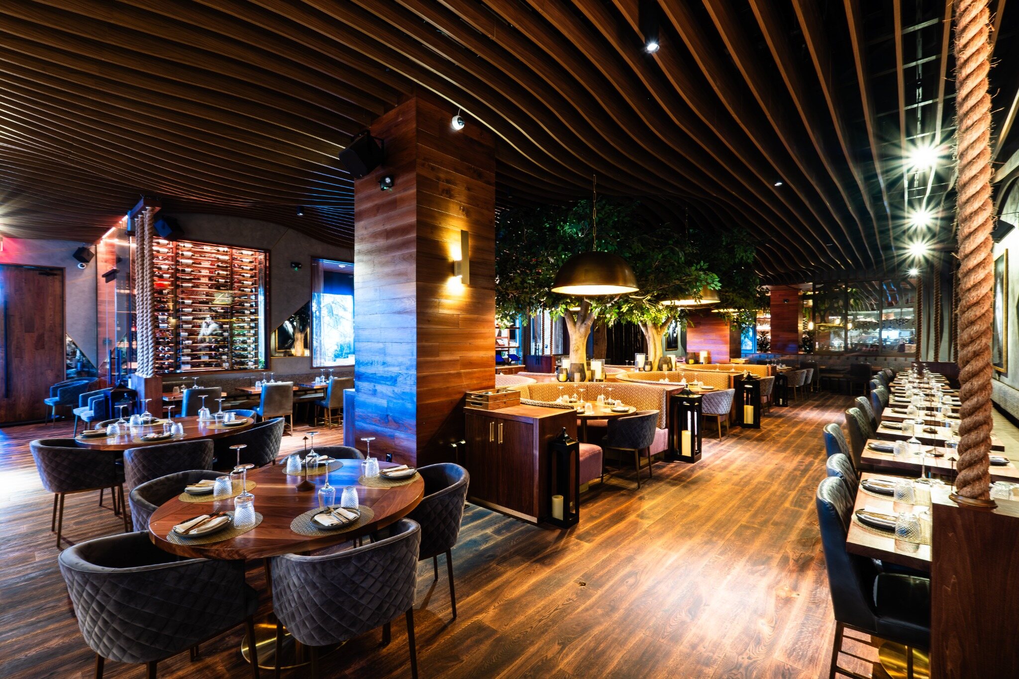 Completed Toca Madera dining room with custom wood ceilings and architectural millwork